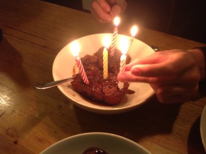 Birthday candles in sticky date pudding.